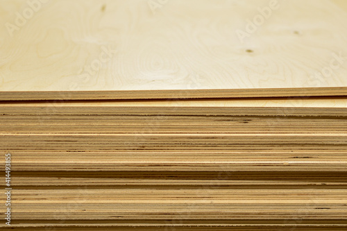 Lumber. Plywood sheets lie in group. Many different rectangular wooden blocks are stacked on top of each other. Wooden background, texture. Building materials in store. Space for text