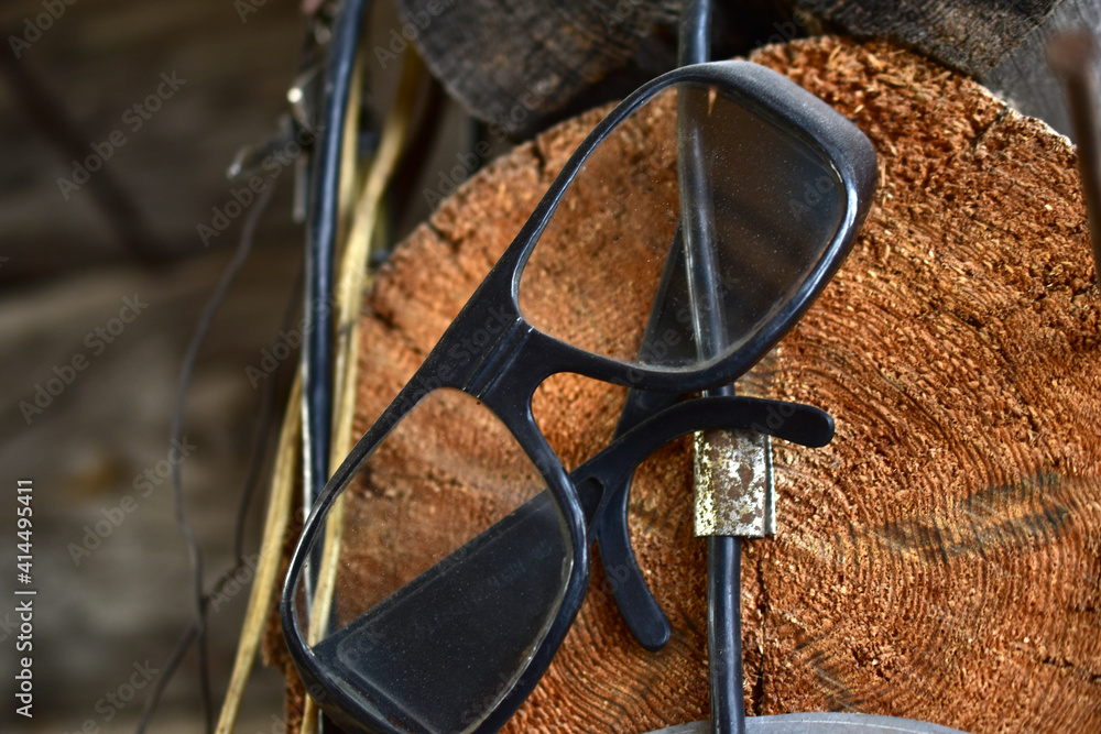 Joiner's glasses Carpenter's sunglasses on a hook in the garage Joiner's glasses Carpenter's sunglasses on a hook in the garage
