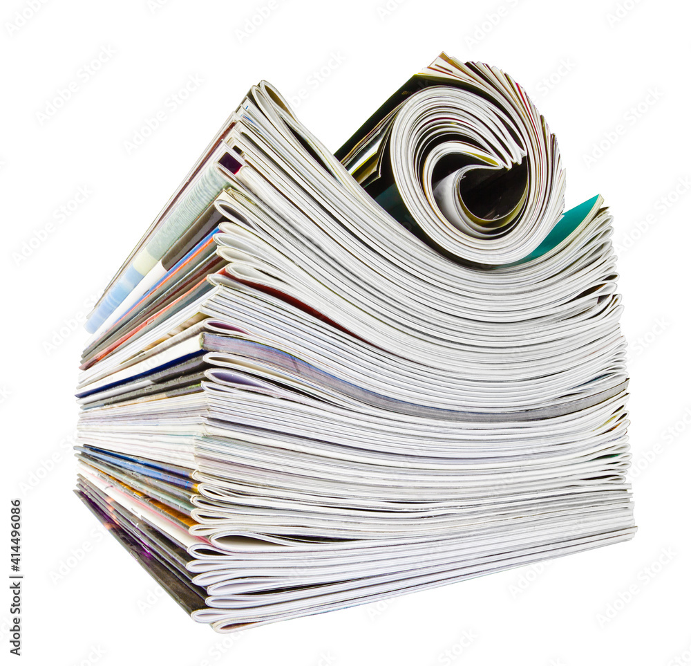 Various stacked and rolled magazines over white Various stacked and rolled magazines over white
