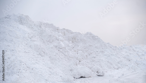 large pile of snow in the street near road, winter season © Mihail