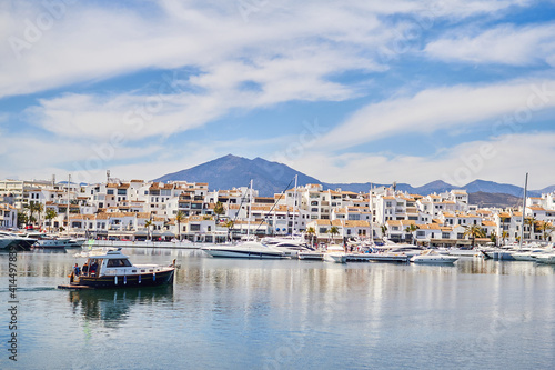 View of Puerto Banus marina with boats and white houses in Marbella town at sunrise, Andalusia, Spain © Daniel
