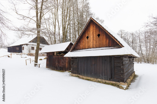 Wooden houses of Vesely Kopec folk museum. Czech rural architecture. Vysocina, Czech Republic. Traditional wooden timbered cottage in winter. Folk open air museum. Most popular place in highlands. photo