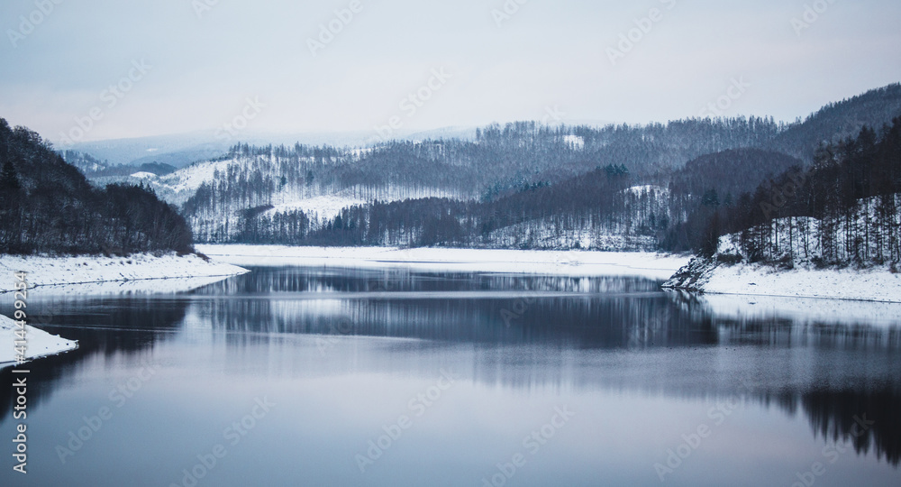Winter landscape at Soesetalsperre in Harz Mountains National Park, Germany. Moody snow scenery in Germany