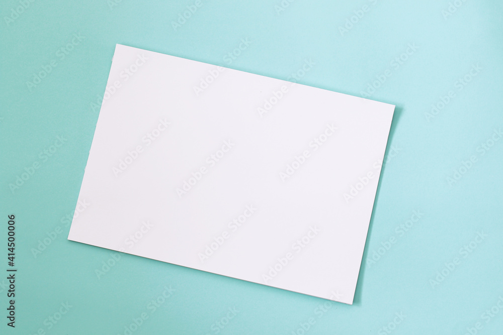 blank paper mock up on mint green background blank paper mock up on mint green background