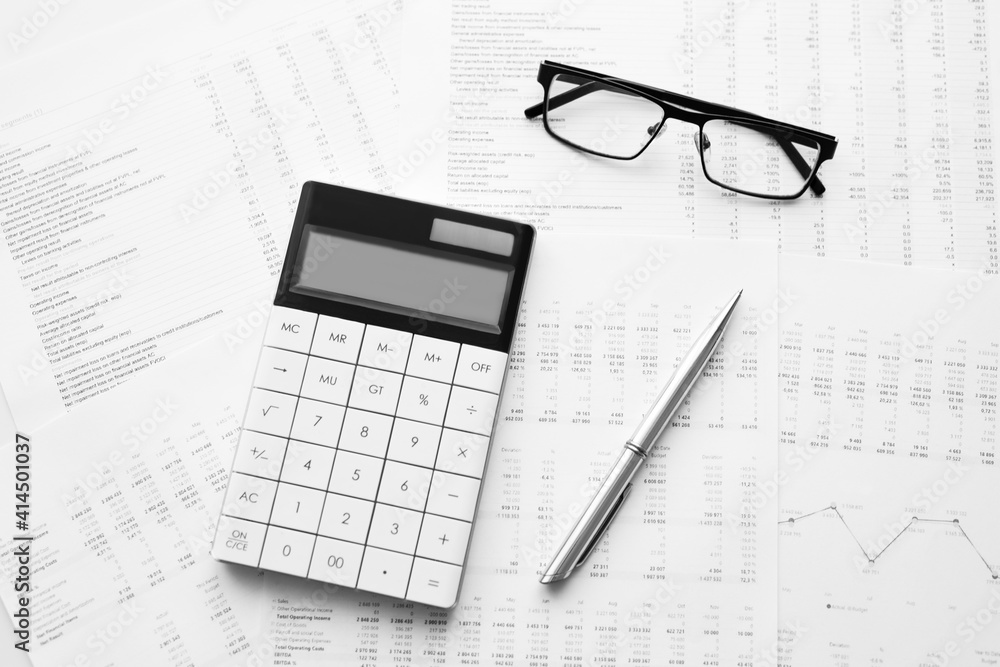 Calculator with pen on stock market analysis. Concept of Business, Finance and Audit research. Calculator with pen on stock market analysis. Concept of Business, Finance and Audit research.