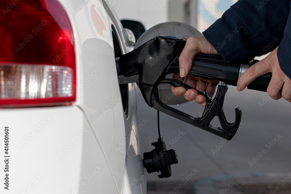 pouring gasoline with the pump hose pouring gasoline with the pump hose