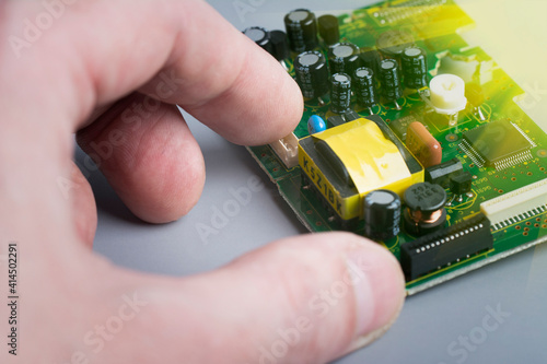 Technician hold pcb in hand. Electronic components on printes circuit board. Technical support and repair. Electronics Manufacturing Services. photo