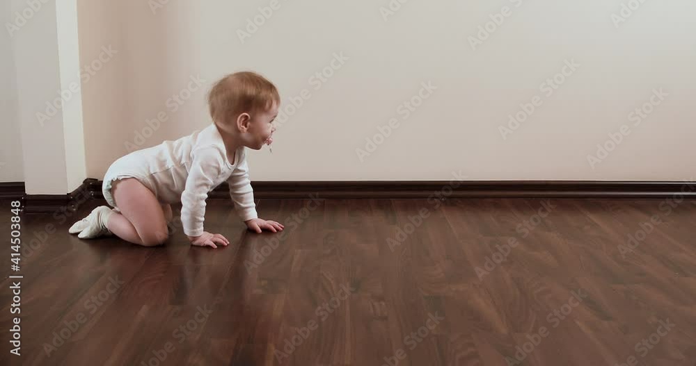 little baby girl with nipple, crawling and sitting on the floor little baby girl with nipple, crawling and sitting on the floor