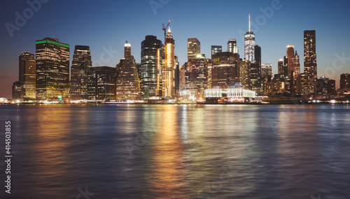 Manhattan skyline reflected in water at dusk, New York City, USA. © MaciejBledowski