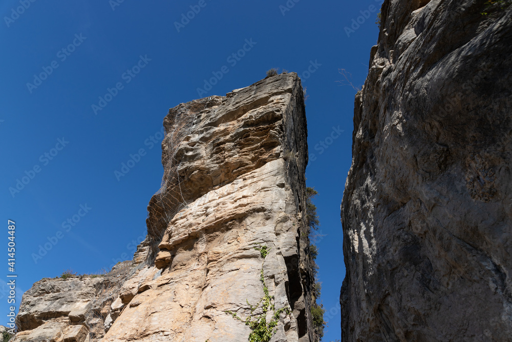 Steep cliff with Protection wire mesh against falling rocks from the mountains