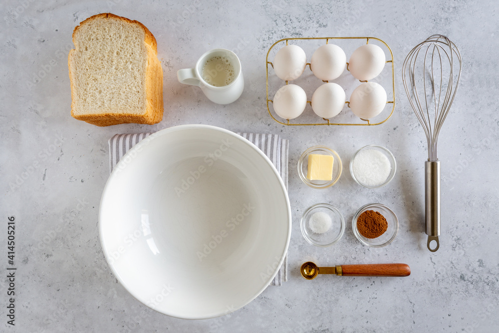 Flay lay of ingredients for making french toast (or wentelteefjes in Dutch) on white grey background, view from above Flay lay of ingredients for making french toast (or wentelteefjes in Dutch) on white grey background, view from above