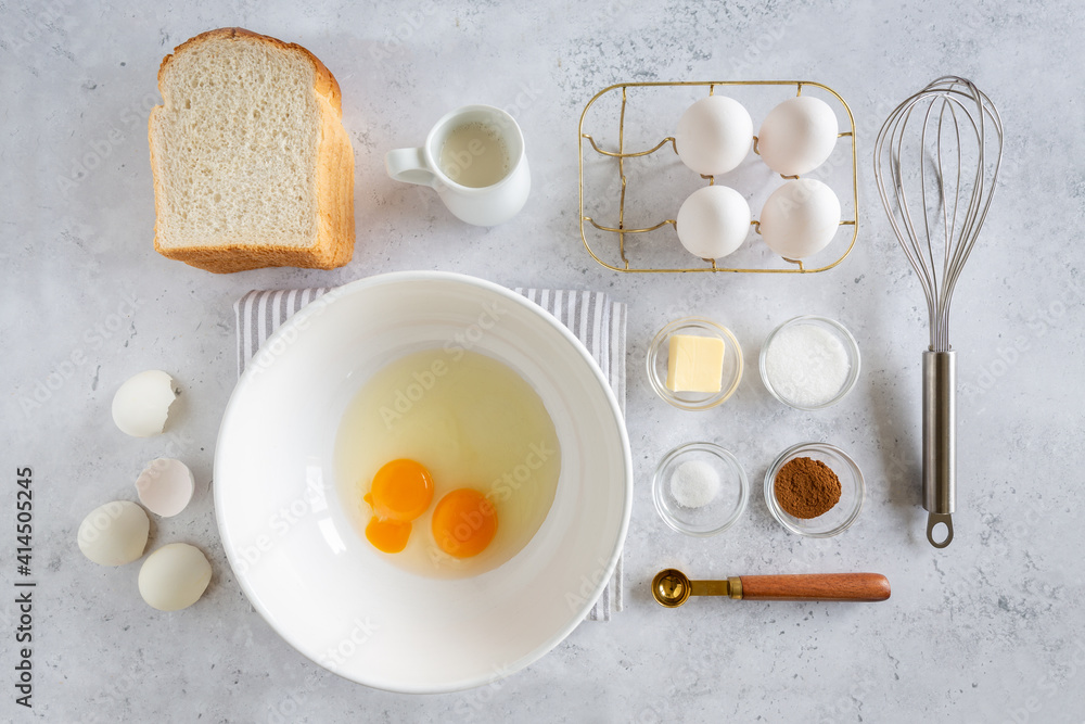 Flay lay of ingredients for making french toast (or wentelteefjes in Dutch) on white grey background, view from above Flay lay of ingredients for making french toast (or wentelteefjes in Dutch) on white grey background, view from above