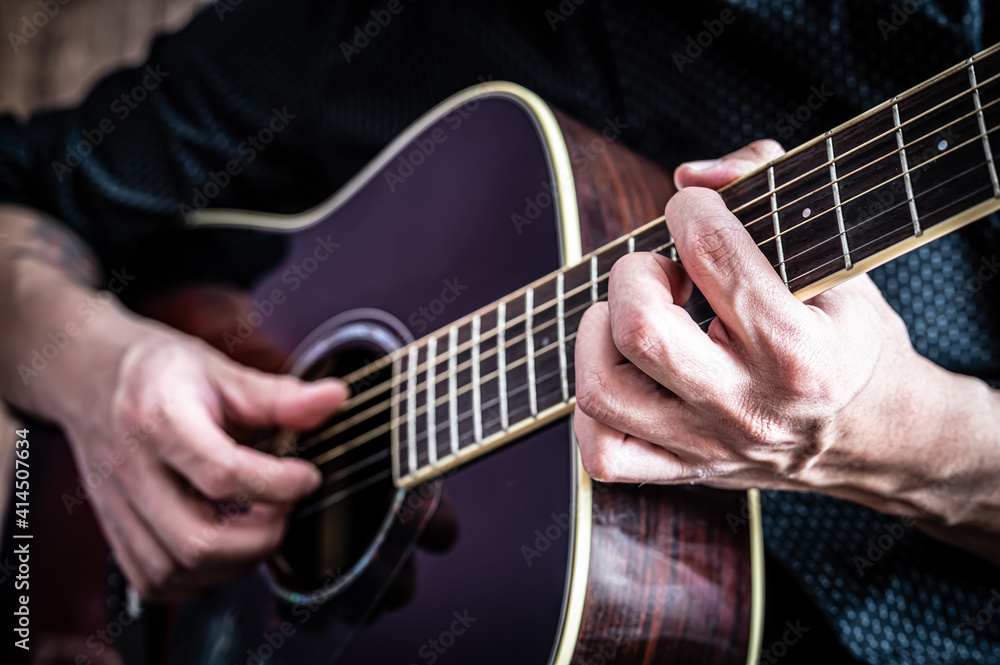 man playing an acoustic guitar