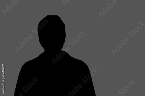 the black silhouette of an unknown person on a gray background copies the space. the concept of an anonymous person