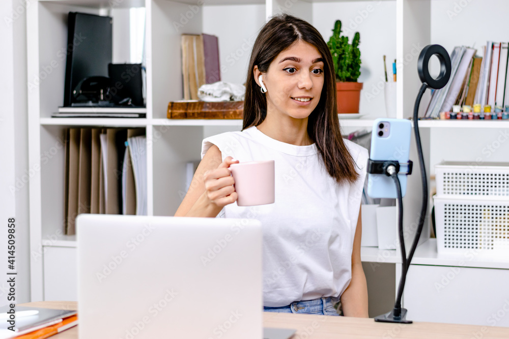 Girl blogger influencer talking camera live recording video blog on social network at home.Social media live streaming concept. Girl blogger influencer talking camera live recording video blog on social network at home.Social media live streaming concept.