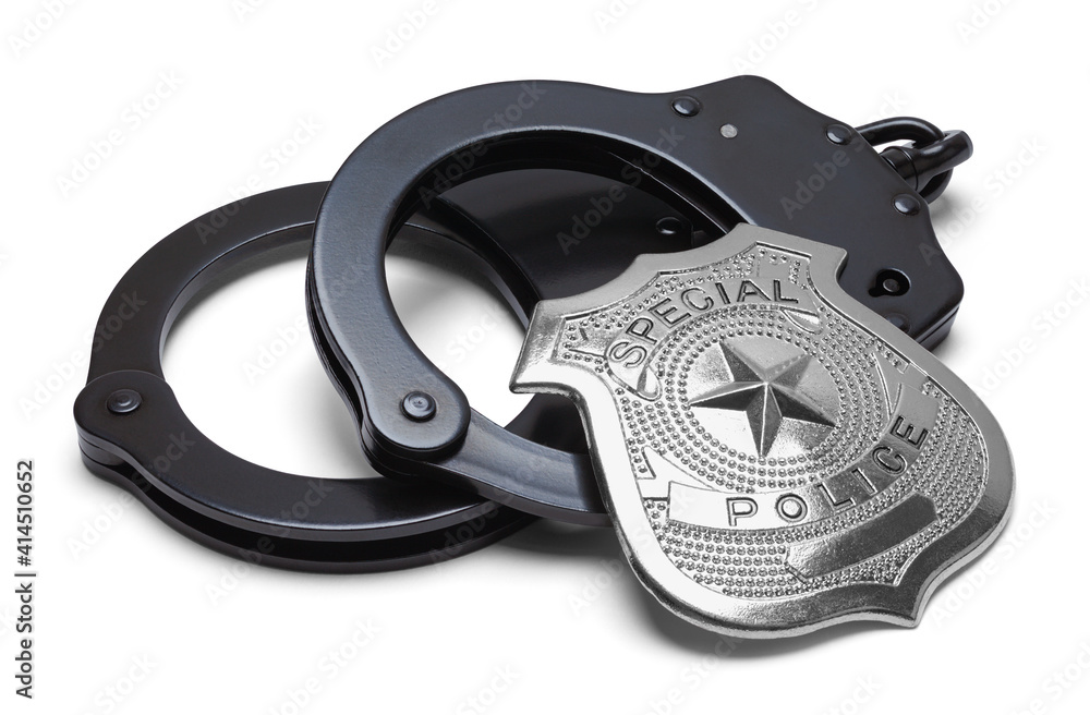 Obraz premium Black Handcuffs with Police Badge Cut Out