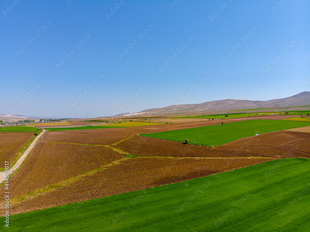Aerial view to the fertile and arable fields in the spring season ready for sowing Aerial view to the fertile and arable fields in the spring season ready for sowing