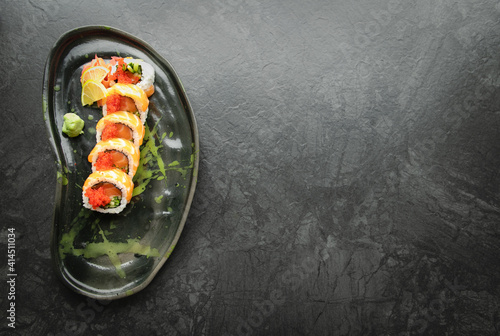 Sushi roll with salmon and caviar, close-up