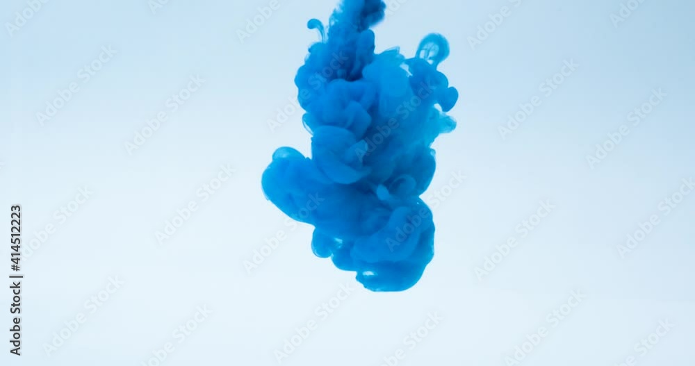 Blue ink water explosion from above in slow motion. Acrylic ink in ...