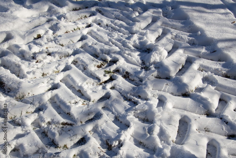 Tractor tire tracks in the snow in winter Tractor tire tracks in the snow in winter