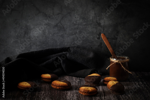 Chocolate chips cookies and hot chocolate on a dark background. Moody food photo