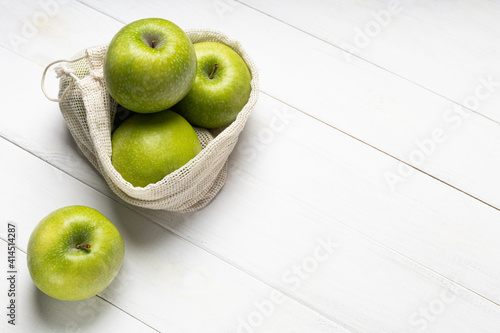 Fresh green apples in an eco-friendly fruit bag