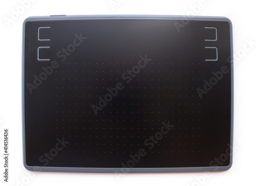 Black graphic design tablet with control buttons on a white background. photo