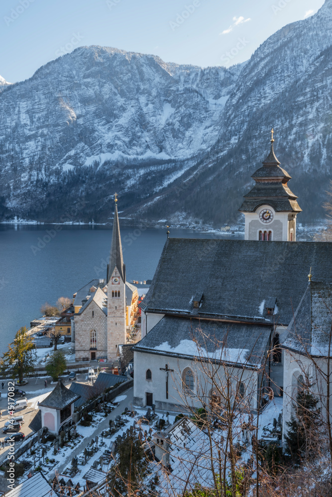 Hallstatt old town in winter blue day with church with tower in Austria