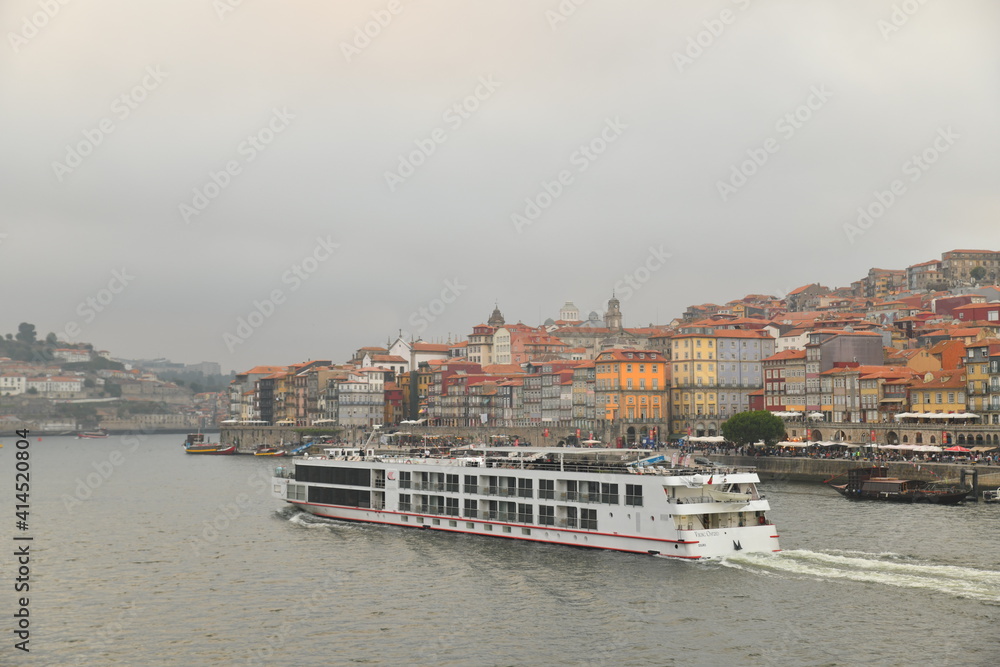 Tourist boat passing by the side of a tourist city OPORTO