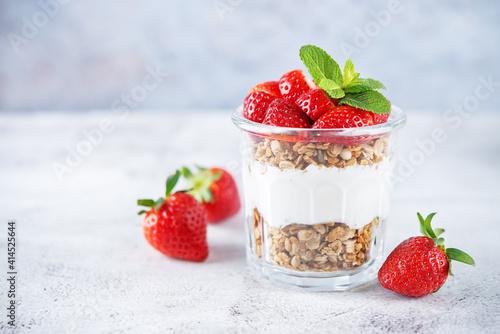 Strawberry Greek yogurt granola parfait in a glass