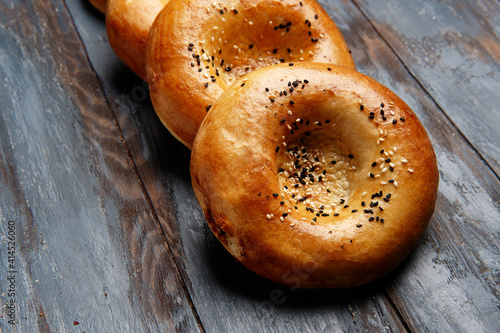 National uzbek bread on wood background. Traditional food. Top view