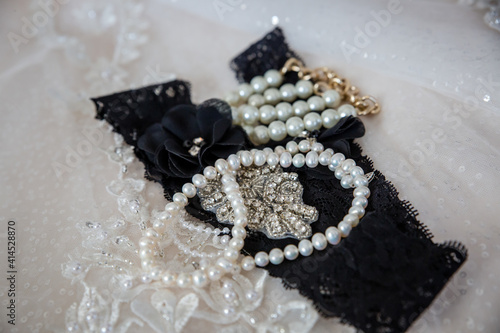 Fototapeta Naklejka Na Ścianę i Meble -  Black bridal garter and pearl jewelry
