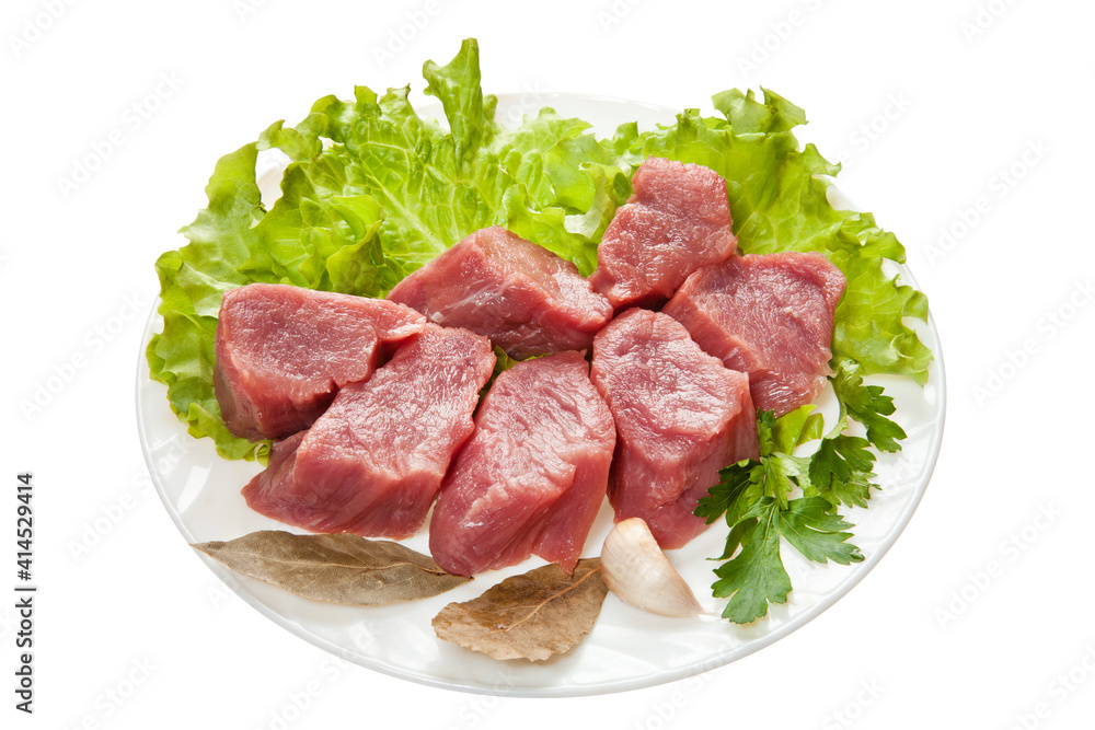 Pieces of raw meat on a white plate is isolated on a white background Pieces of raw meat on a white plate is isolated on a white background