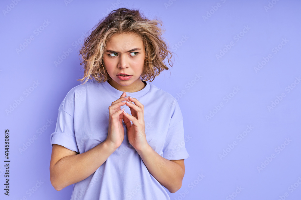 cunning caucasian woman stand looking at side, she plans to do something, isolated purple background cunning caucasian woman stand looking at side, she plans to do something, isolated purple background