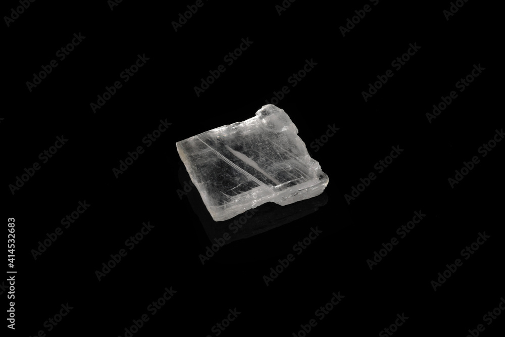 Natural mineral rock specimen - raw Gypsum stone from Gaurgak, Turkmenistan on black glass background.