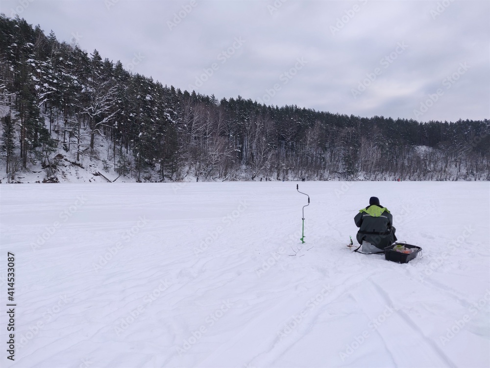 fisherman on ice fishing alone, Green Lakes