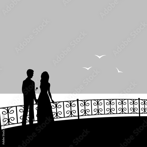 Silhouette of a couple in love on the background of the evening sea. A man gives a girl a flower. Vector romantic illustration.