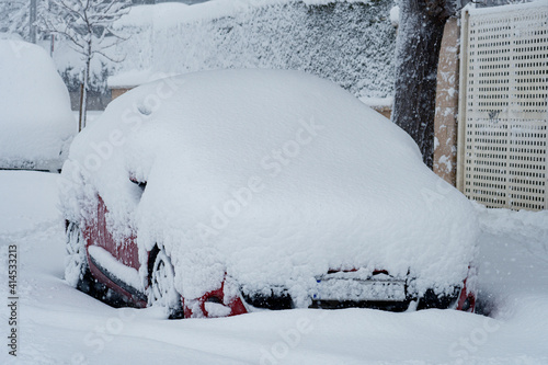 Frozen car covered by snow and ice © David