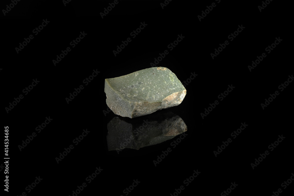 Natural mineral Ophicalcite is a calcified calcite from Satka, Ural, Russia on black glass background. Natural mineral Ophicalcite is a calcified calcite from Satka, Ural, Russia on black glass background.