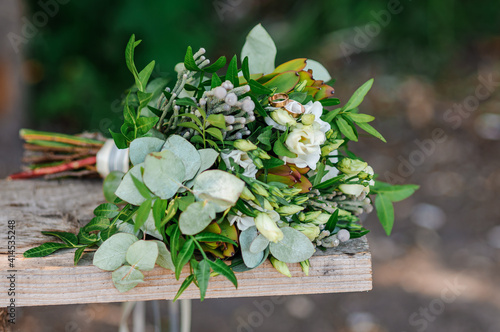 Bridal bouquet with white flowers and green branches on a white background