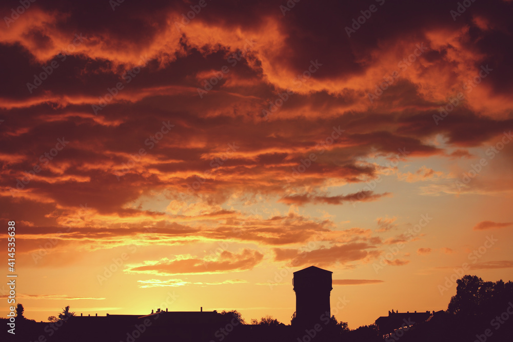 Sonnenuntergang hinter Skyline mit Wasserturm Sonnenuntergang hinter Skyline mit Wasserturm