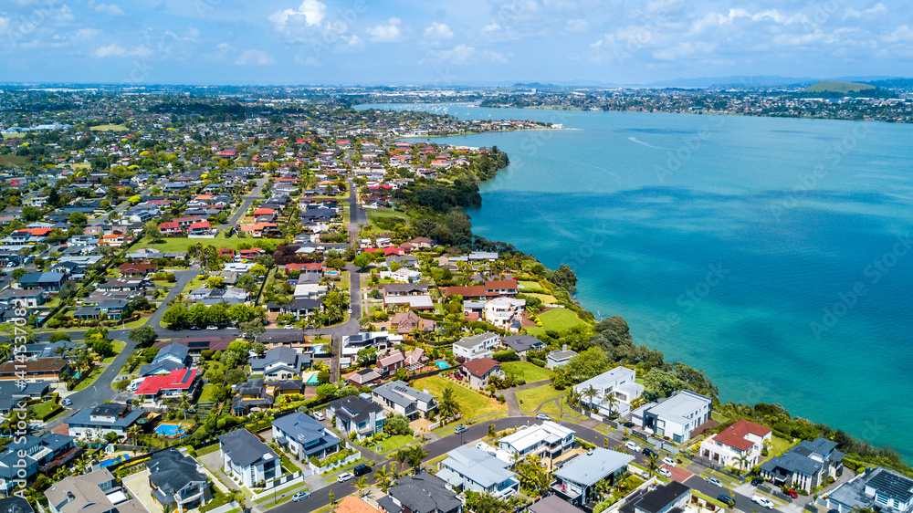 Aerial view of residential houses on a shore of a beautiful. Auckland, New Zealand.