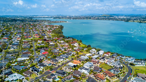 Aerial view of residential houses on a shore of a beautiful. Auckland, New Zealand. © Dmitri