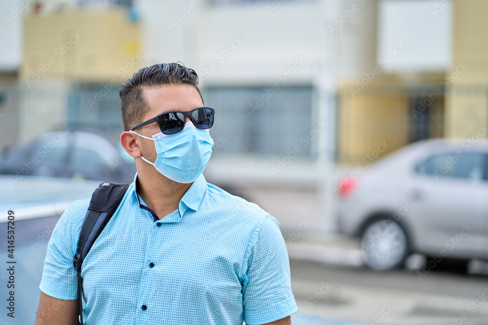 street portrait of a handsome young ecuadorian wearing mask in guayaquil city street portrait of a handsome young ecuadorian wearing mask in guayaquil city