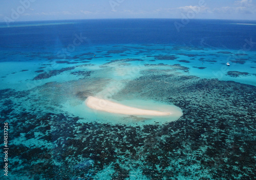 Great Barrier Reef with anchored yacht near Carins, Queensland, Australia - bird's eye view.