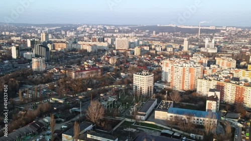 Aerial drone view of Chisinau. Multiple commercial and residential buildings. Bare trees, winter photo