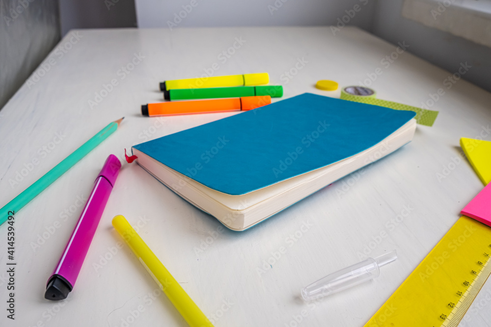 Turquoise cover planner with a pen, markers, ruler, stickers.. Planning and smart time management concept Turquoise cover planner with a pen, markers, ruler, stickers.. Planning and smart time management concept