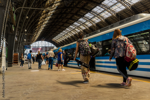 Panoramic view on a sunny day of one of the platforms of the Retiro railway terminal in Buenos Aires, built of iron and glass.