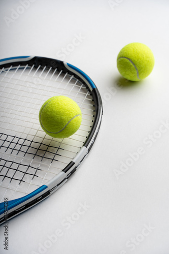 Tennis racket and tennis balls on a white background. Copy space. High quality photo