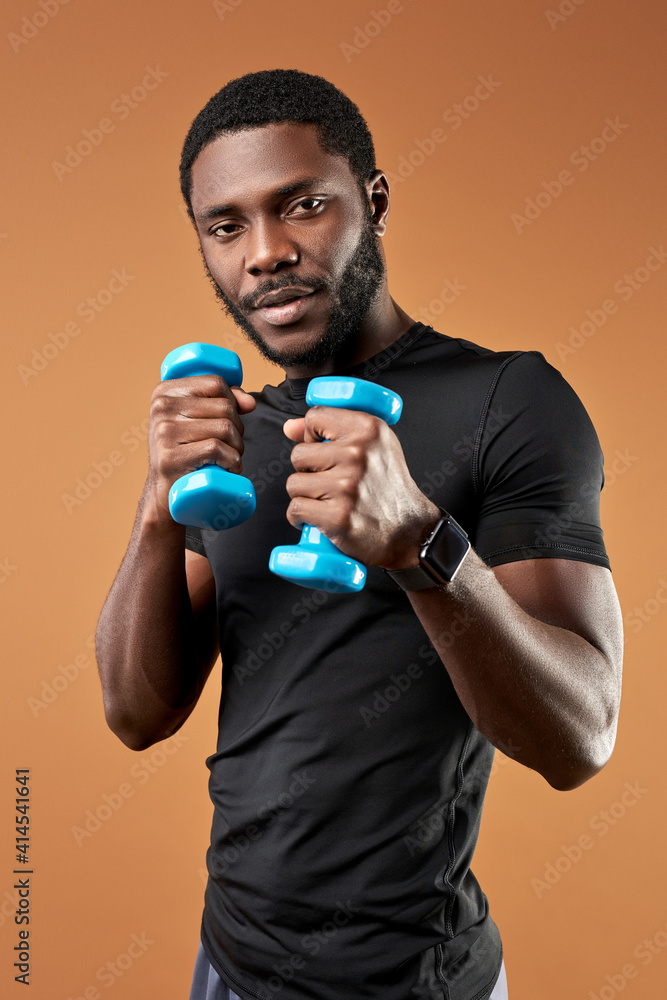 afro american boxer training, exercising with weights in hands, holding dumbbells for better pumping arm muscles afro american boxer training, exercising with weights in hands, holding dumbbells for better pumping arm muscles
